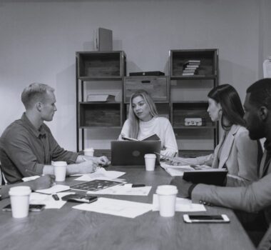 men and women discussion around a table