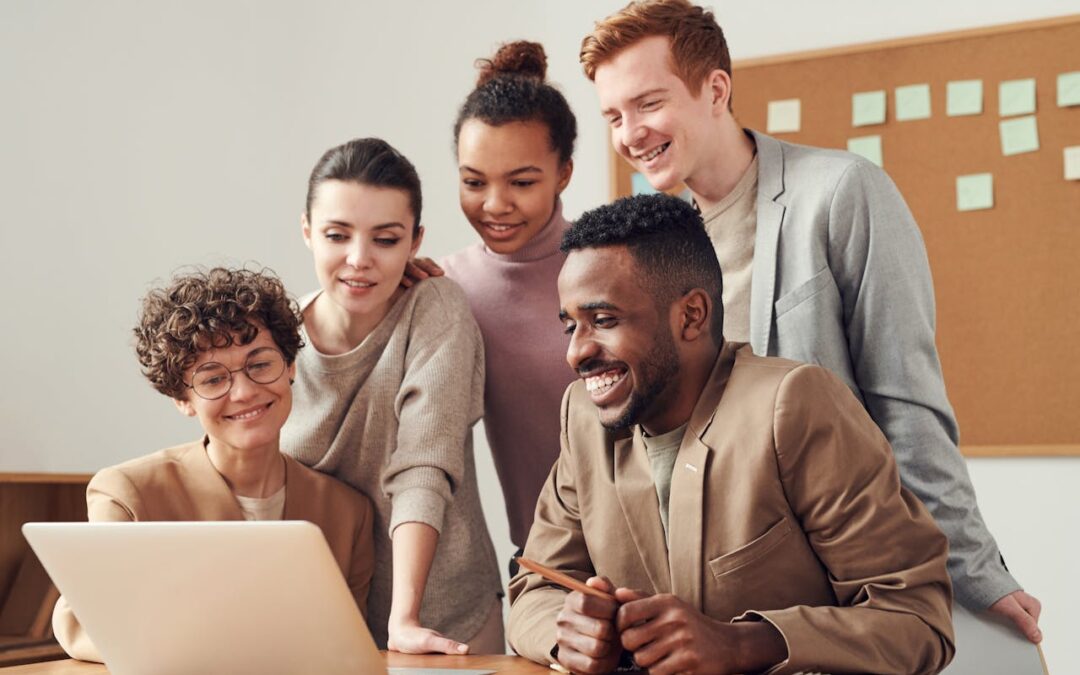 a team of five women and men looking at a laptop screen; lead from any stance in Kantor's 4-player model