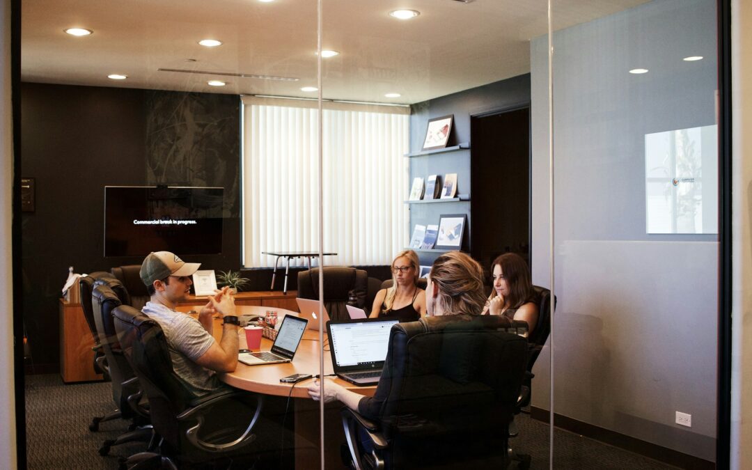 team learning; men and women sitting around a table in a conference room